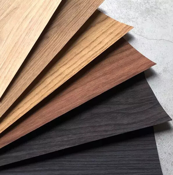 3M DI-NOC wood grain architectural film samples in oak, walnut, and dark wood finishes